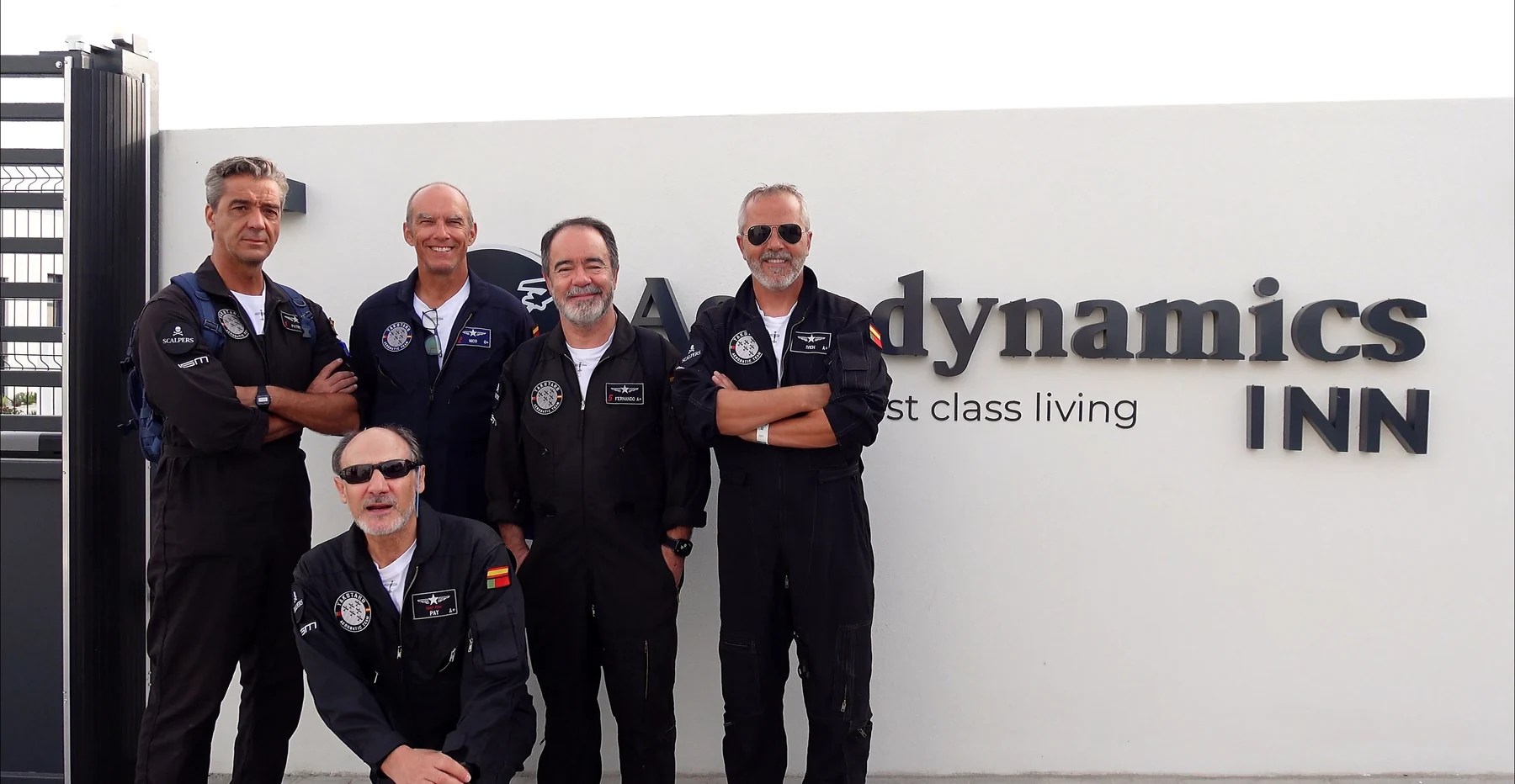 Members of Yakstars beside the Aerodynamics Inn name.