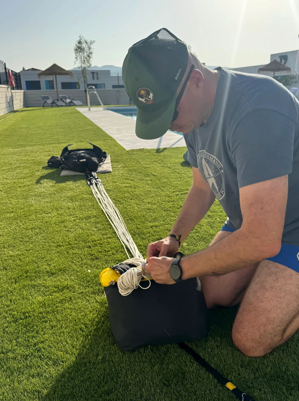 A Guardia Civil parachutist prepares equipment in the outdoor areas of Aerodynamics Inn.
