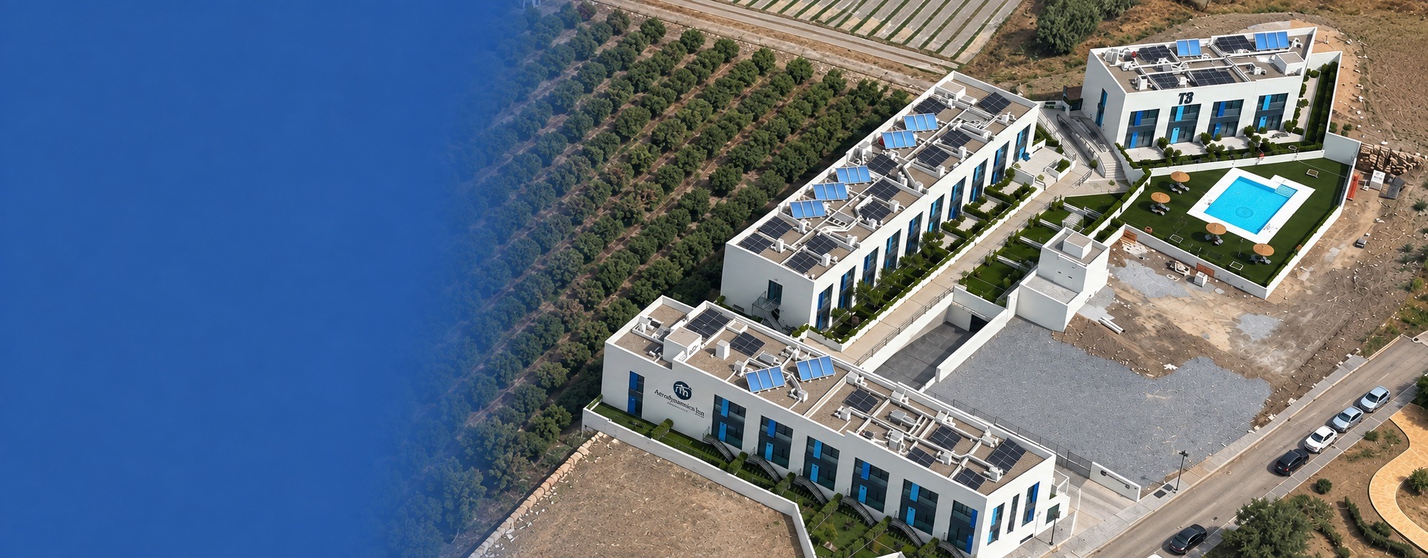 Aerial view of Aerodynamics Inn with the façade logo visible, together with the residence and swimming pool.